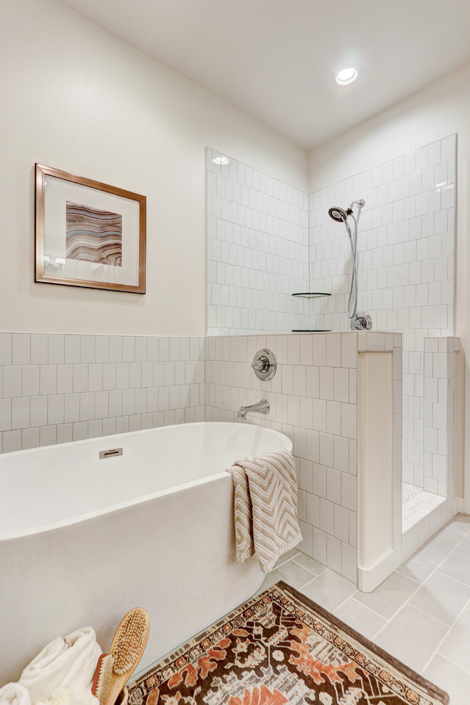 Photo of a medium sized classic ensuite bathroom in Oklahoma City with shaker cabinets, light wood cabinets, a freestanding bath, a corner shower, a one-piece toilet, white tiles, metro tiles, white walls, ceramic flooring, a submerged sink, engineered stone worktops, grey floors, a hinged door and white worktops.