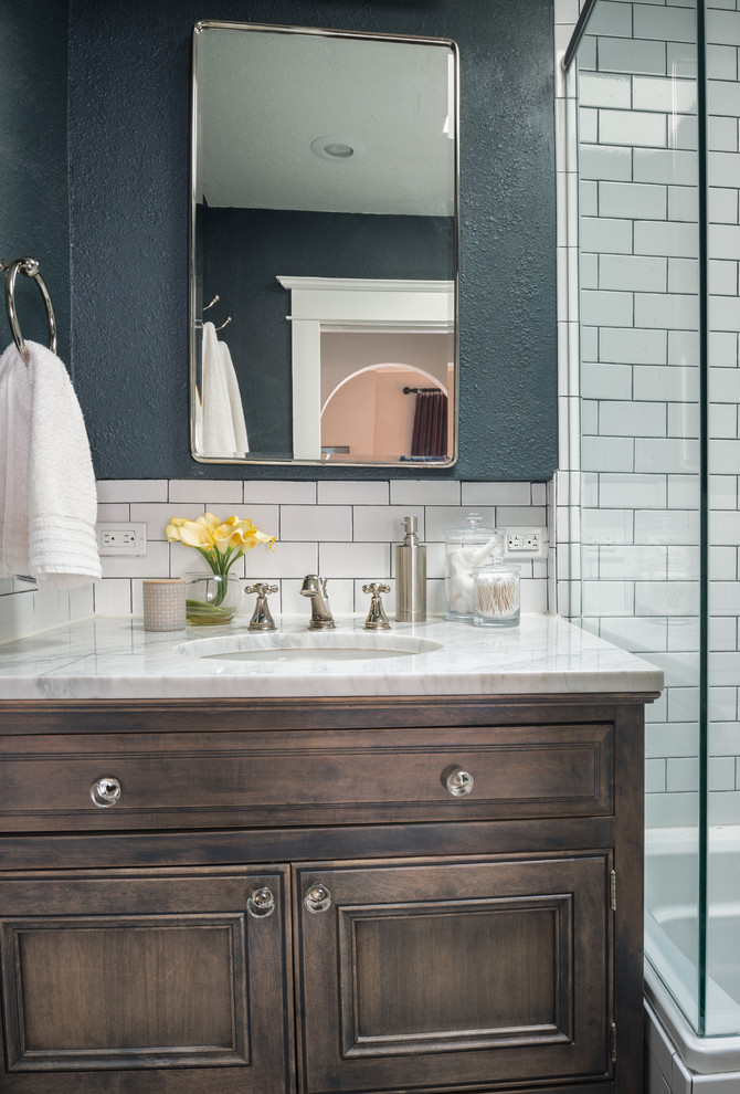 Small elegant white tile and subway tile porcelain tile and black floor bathroom photo in Denver with recessed-panel cabinets, brown cabinets, a two-piece toilet, green walls, an undermount sink, granite countertops, a hinged shower door and yellow countertops