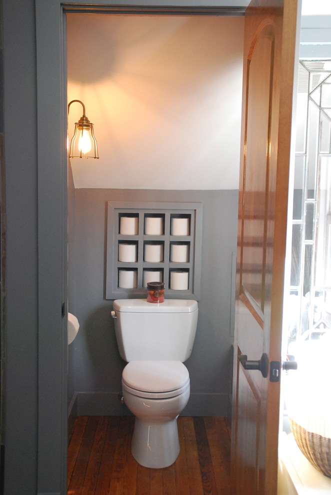 Large industrial ensuite bathroom in DC Metro with a submerged sink, a one-piece toilet, flat-panel cabinets, grey cabinets, marble worktops, grey walls and light hardwood flooring.
