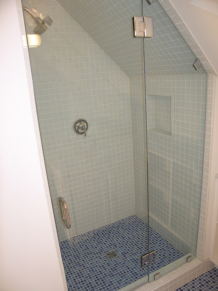 Photo of a small contemporary bathroom in DC Metro with recessed-panel cabinets, an alcove shower, a one-piece toilet, blue tiles, white walls, mosaic tile flooring, a submerged sink and mosaic tiles.