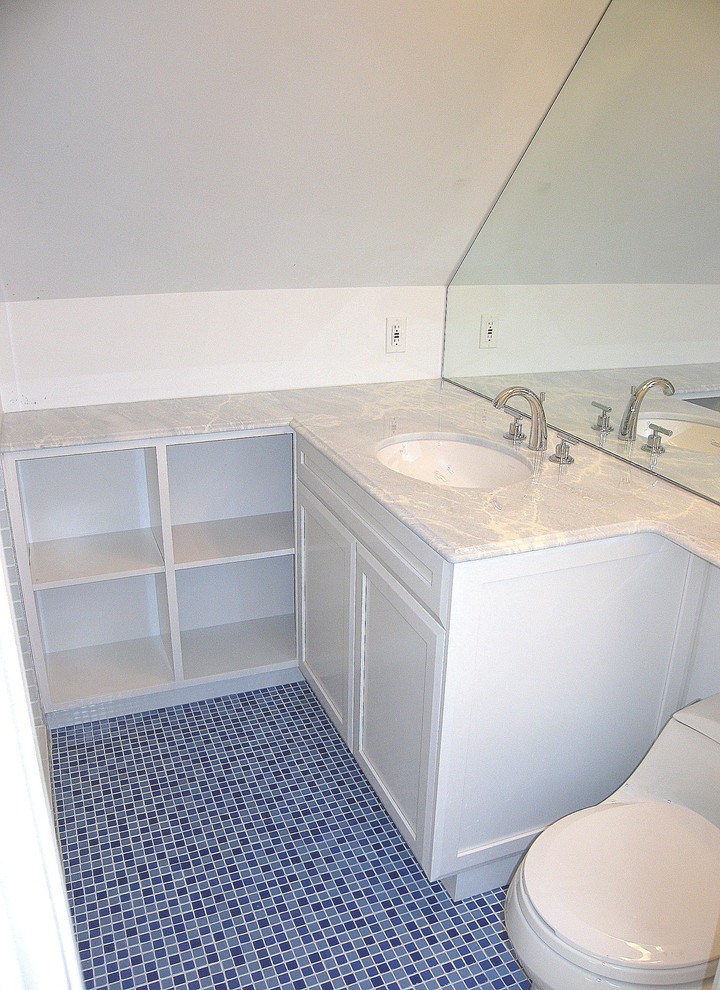 Small contemporary bathroom in DC Metro with recessed-panel cabinets, white cabinets, an alcove shower, a one-piece toilet, blue tiles, white walls, mosaic tile flooring, a submerged sink and marble worktops.