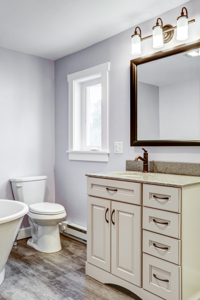 This is an example of a medium sized traditional ensuite bathroom in Other with beige cabinets, a freestanding bath, an alcove shower, purple walls, vinyl flooring, a submerged sink, marble worktops, brown floors, a hinged door, beige worktops, a single sink and a freestanding vanity unit.
