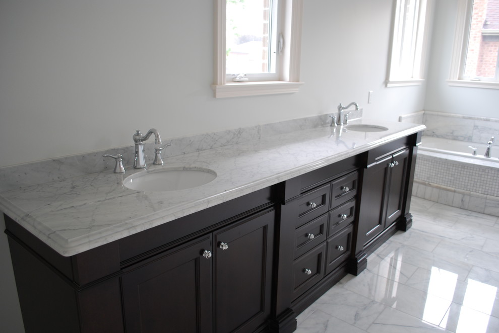 Mid-sized elegant bathroom photo in Toronto with an undermount sink, recessed-panel cabinets, dark wood cabinets and granite countertops