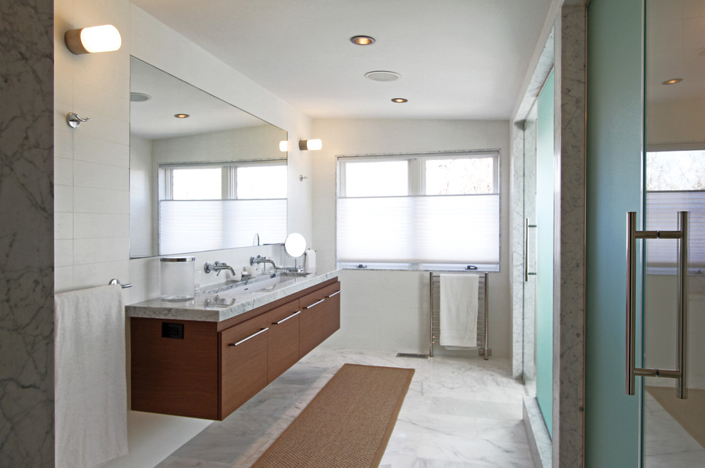 Medium sized contemporary ensuite bathroom in New York with a trough sink, flat-panel cabinets, medium wood cabinets, an alcove shower, marble worktops, white tiles, stone slabs, white walls and medium hardwood flooring.
