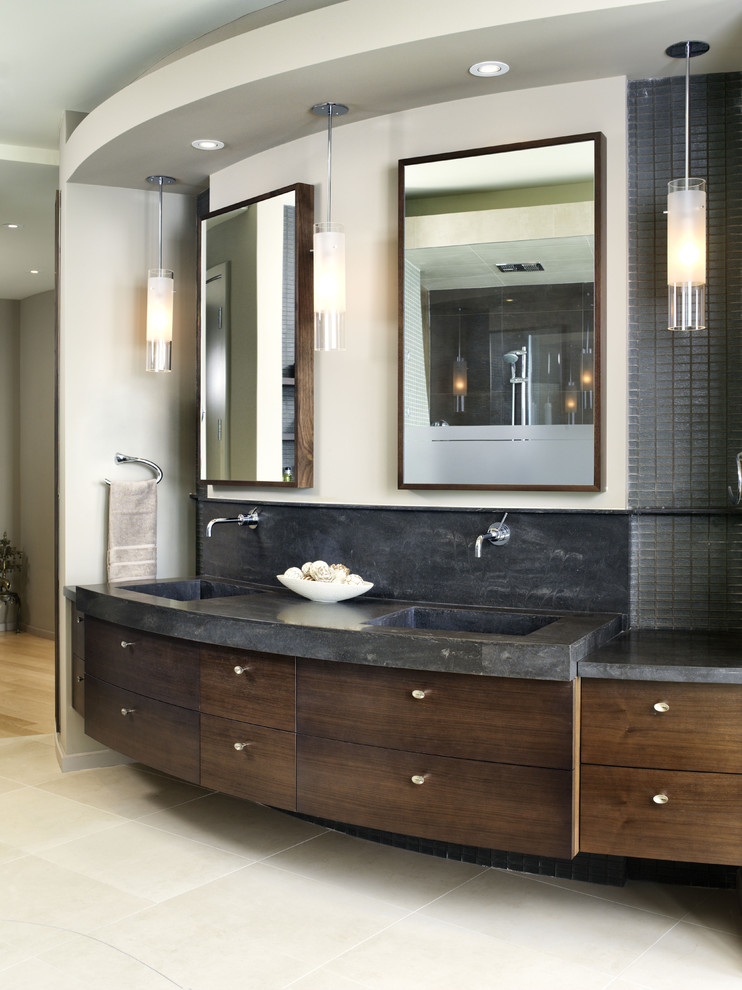 Photo of a large contemporary ensuite bathroom in Toronto with an integrated sink, flat-panel cabinets, dark wood cabinets, solid surface worktops, brown tiles, glass tiles and porcelain flooring.