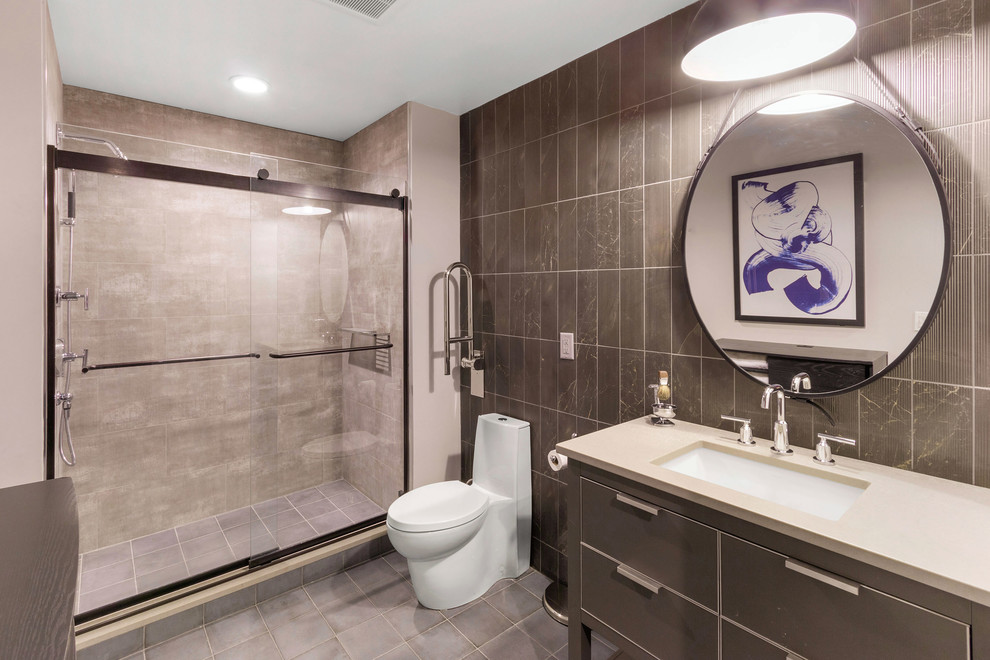 Example of a mid-sized minimalist 3/4 black tile and porcelain tile ceramic tile and blue floor bathroom design in Milwaukee with furniture-like cabinets, gray cabinets, a one-piece toilet, gray walls, an undermount sink, quartzite countertops and gray countertops