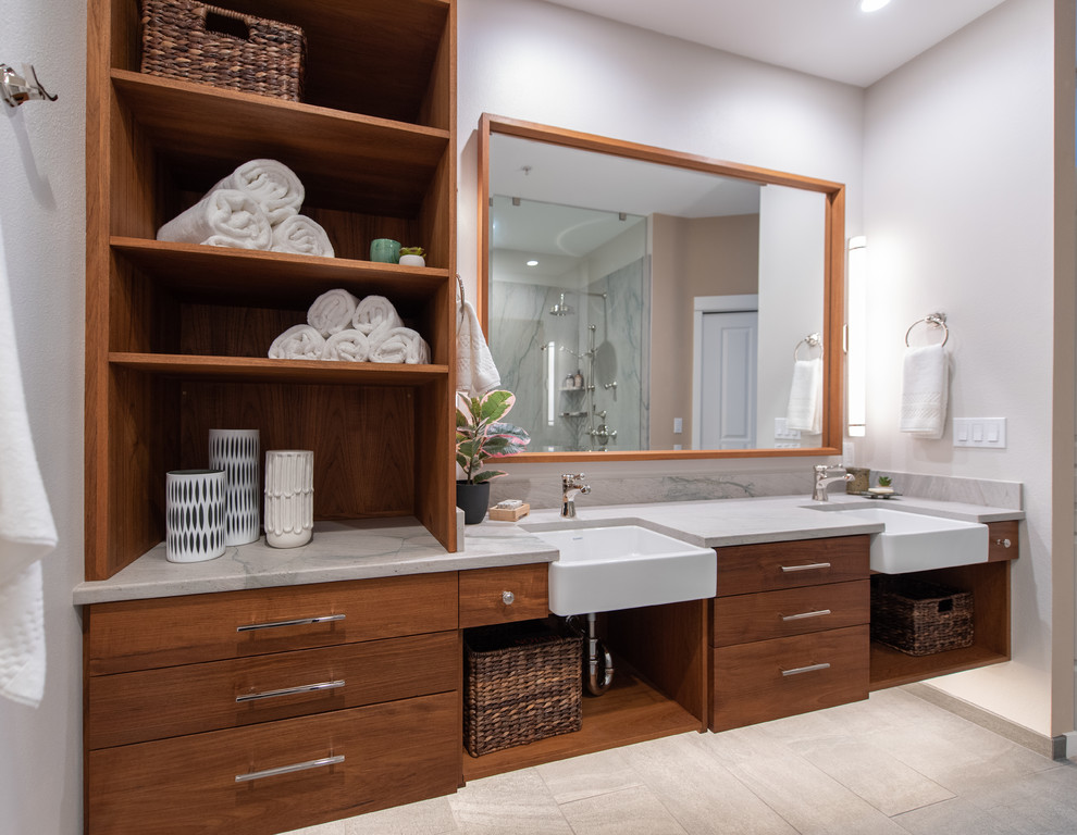 Medium sized contemporary ensuite bathroom in Seattle with flat-panel cabinets, medium wood cabinets, a built-in shower, a two-piece toilet, white tiles, white walls, porcelain flooring, a submerged sink, quartz worktops, grey floors, an open shower and white worktops.