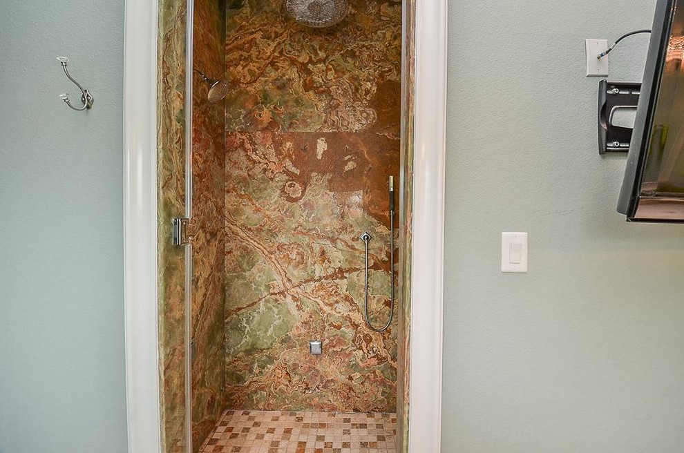 На фото: большая ванная комната в классическом стиле с фасадами с выступающей филенкой, белыми фасадами, японской ванной, унитазом-моноблоком, разноцветной плиткой, плиткой из листового камня, синими стенами, полом из травертина, врезной раковиной, столешницей из оникса, бежевым полом, душем с распашными дверями и разноцветной столешницей