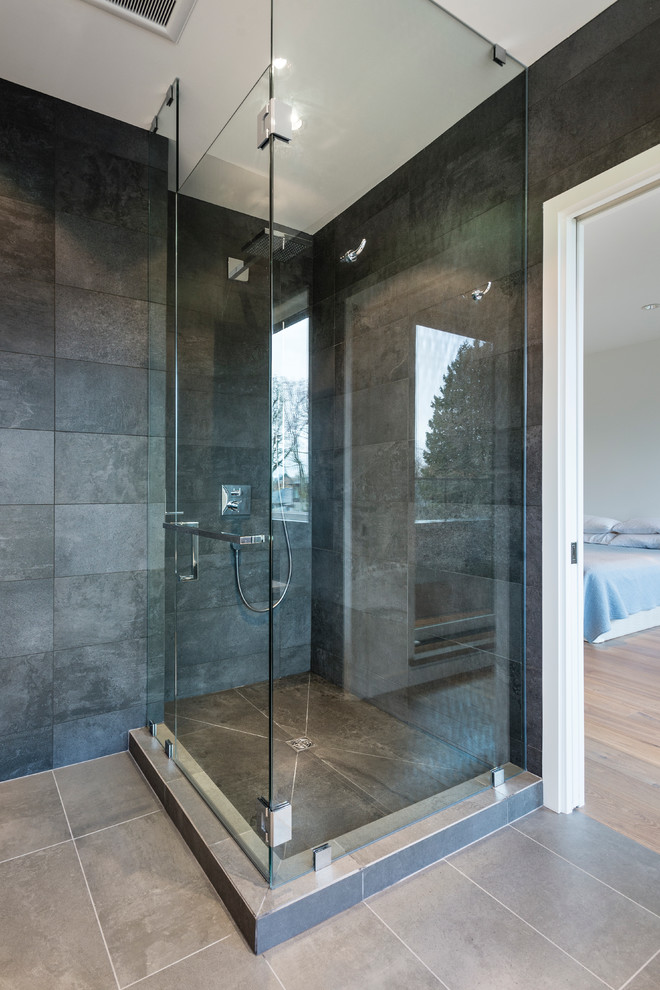 Example of a mid-sized trendy master black tile and porcelain tile porcelain tile bathroom design in Vancouver with flat-panel cabinets, medium tone wood cabinets, a wall-mount toilet, gray walls, an undermount sink and granite countertops