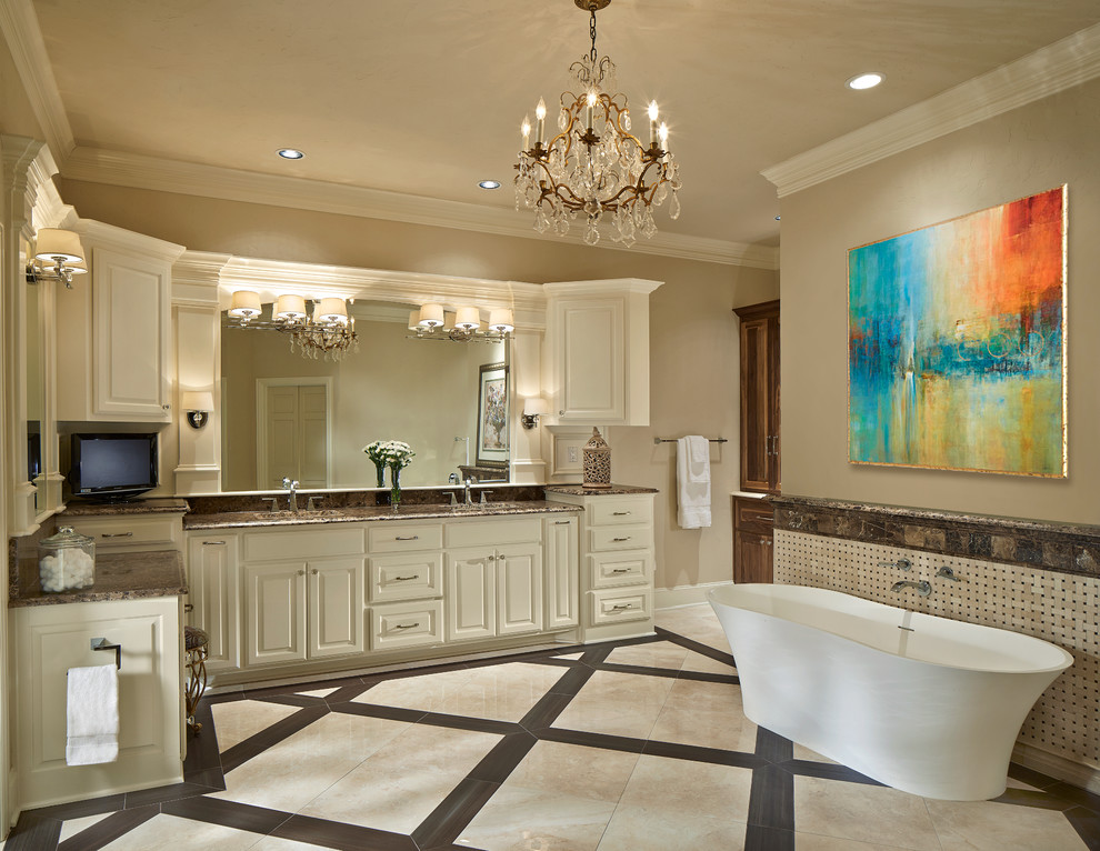 Freestanding bathtub - large transitional master beige tile and ceramic tile ceramic tile freestanding bathtub idea in Dallas with raised-panel cabinets, white cabinets, beige walls, an undermount sink and marble countertops