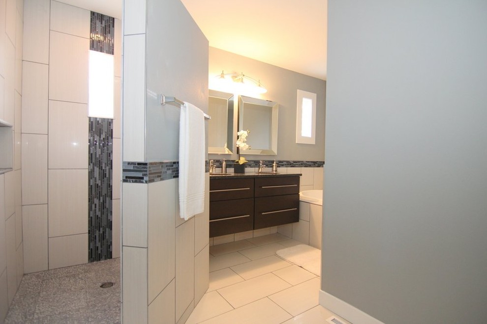 Photo of a medium sized contemporary ensuite bathroom in Wichita with flat-panel cabinets, black cabinets, a built-in bath, a corner shower, a two-piece toilet, matchstick tiles, blue walls, ceramic flooring, a submerged sink and granite worktops.