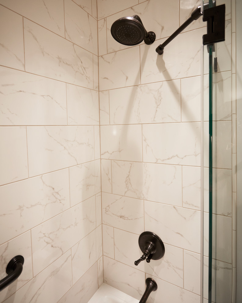 Example of a small classic white tile and marble tile marble floor and brown floor bathroom design in Milwaukee with shaker cabinets, dark wood cabinets, a two-piece toilet, white walls, a drop-in sink, solid surface countertops and a hinged shower door