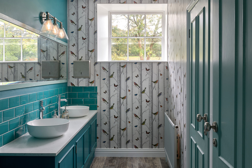 This is an example of a small traditional family bathroom in Hampshire with turquoise cabinets, green tiles, ceramic tiles, multi-coloured walls, granite worktops, white worktops, double sinks, a built in vanity unit, wallpapered walls and recessed-panel cabinets.