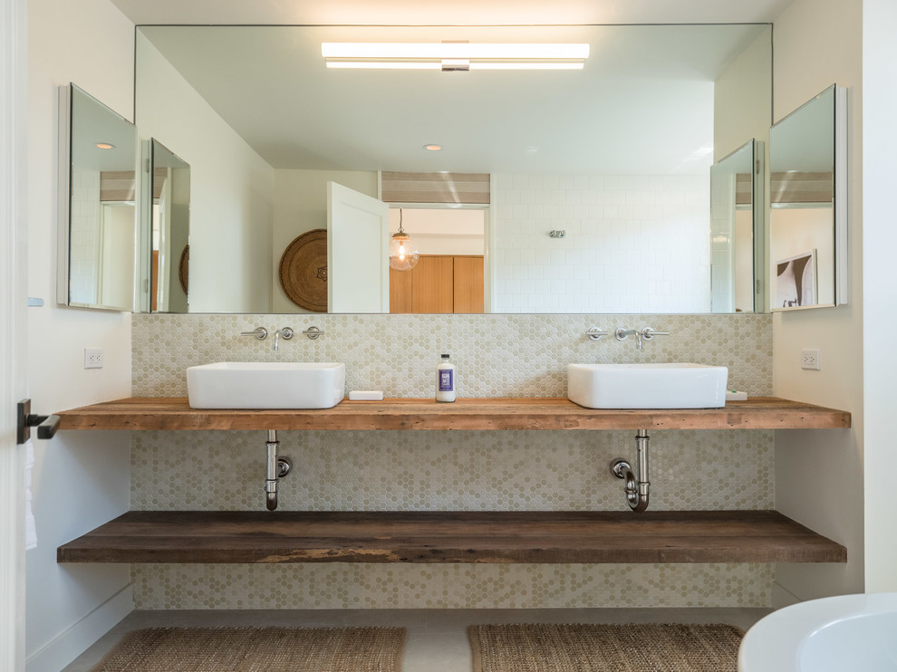 ロサンゼルスにある低価格の中くらいなコンテンポラリースタイルのおしゃれなマスターバスルーム (オープンシェルフ、濃色木目調キャビネット、置き型浴槽、シャワー付き浴槽	、分離型トイレ、緑のタイル、モザイクタイル、白い壁、磁器タイルの床、ベッセル式洗面器、木製洗面台、グレーの床、オープンシャワー) の写真