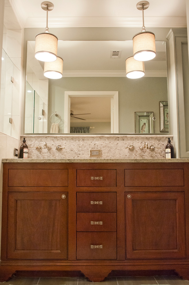 Photo of a small traditional bathroom in Houston with a submerged sink, recessed-panel cabinets, dark wood cabinets, granite worktops, grey tiles, porcelain tiles, green walls and porcelain flooring.