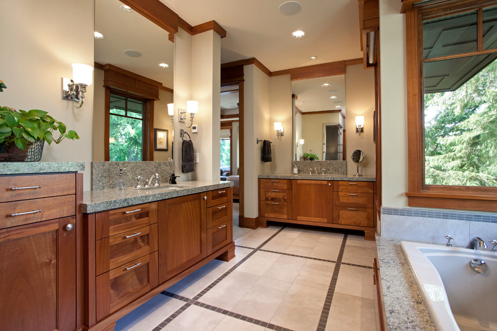 Traditional ensuite bathroom in Minneapolis with a submerged sink, medium wood cabinets, quartz worktops, a built-in bath, grey tiles, ceramic tiles, grey walls and ceramic flooring.