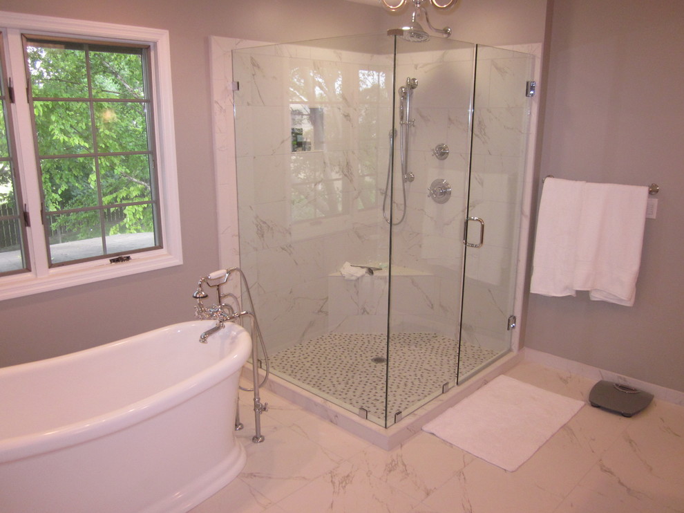 Photo of a large contemporary ensuite bathroom in Other with grey walls, marble flooring, a two-piece toilet, a submerged sink, a freestanding bath, an alcove shower, granite worktops, dark wood cabinets and raised-panel cabinets.