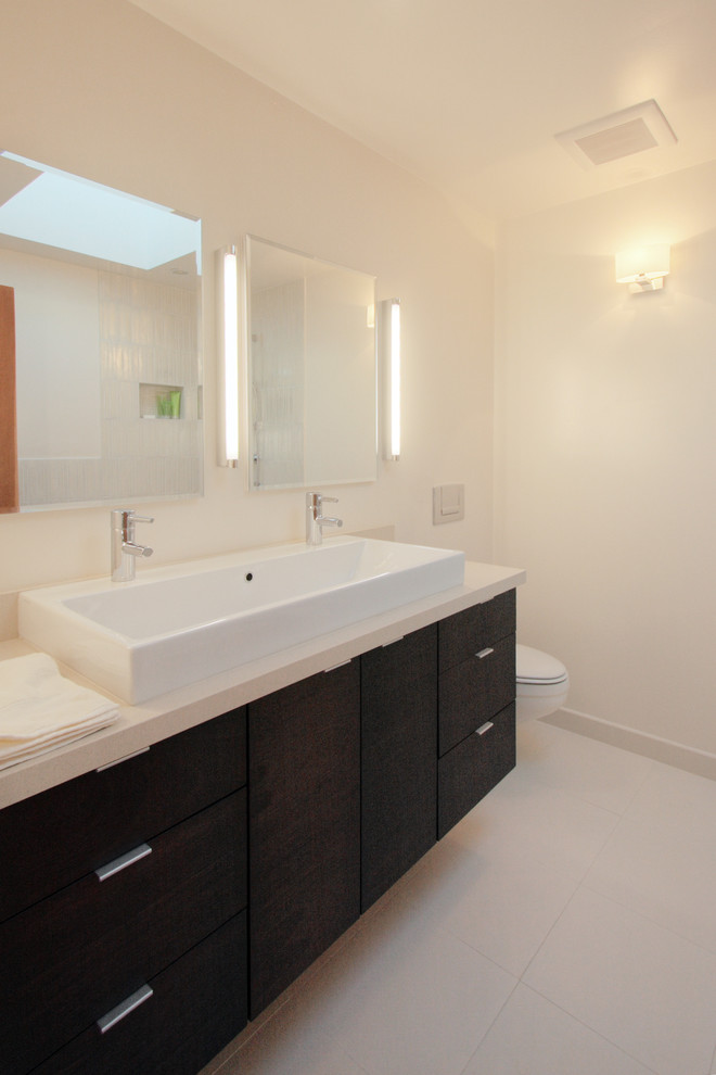 Example of a minimalist bathroom design in San Francisco with flat-panel cabinets and black cabinets