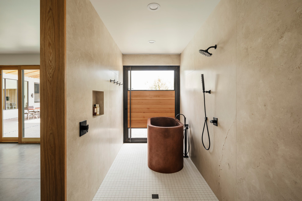 Photo of an ensuite bathroom in Phoenix with flat-panel cabinets, medium wood cabinets, a freestanding bath, a walk-in shower, beige tiles, marble tiles, beige walls, mosaic tile flooring, marble worktops, white floors, an open shower and beige worktops.