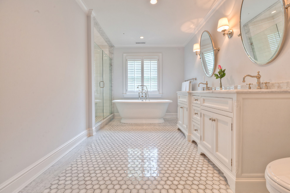 Design ideas for a classic ensuite bathroom in New York with recessed-panel cabinets, white cabinets, a freestanding bath, an alcove shower, white tiles, stone tiles, white walls, marble flooring, a submerged sink and quartz worktops.