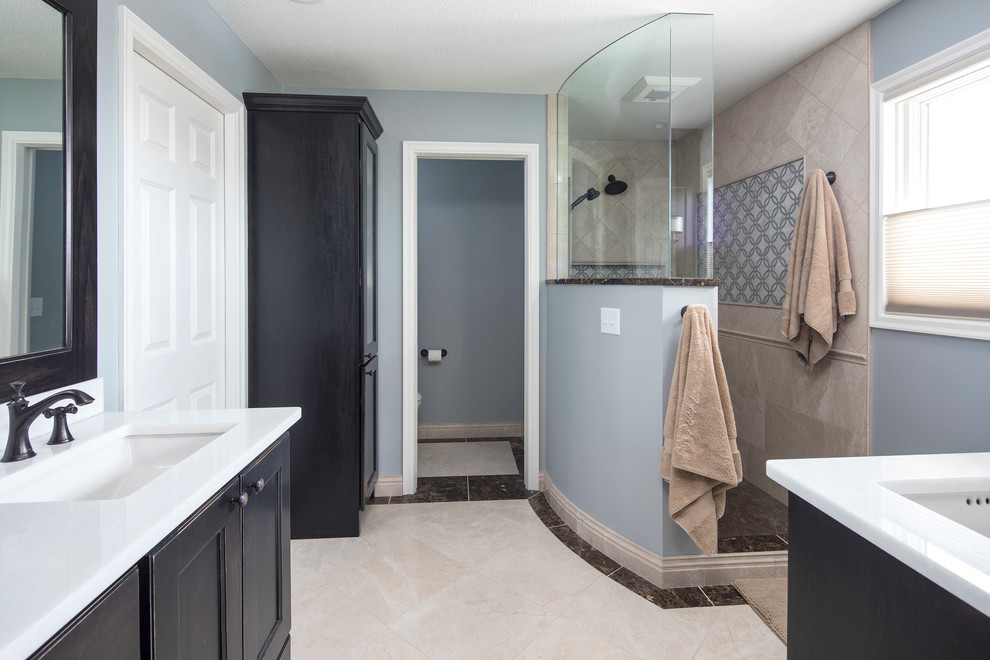 Design ideas for a large contemporary ensuite bathroom in Minneapolis with shaker cabinets, dark wood cabinets, a walk-in shower, a one-piece toilet, black and white tiles, stone tiles, blue walls, ceramic flooring, a submerged sink and engineered stone worktops.