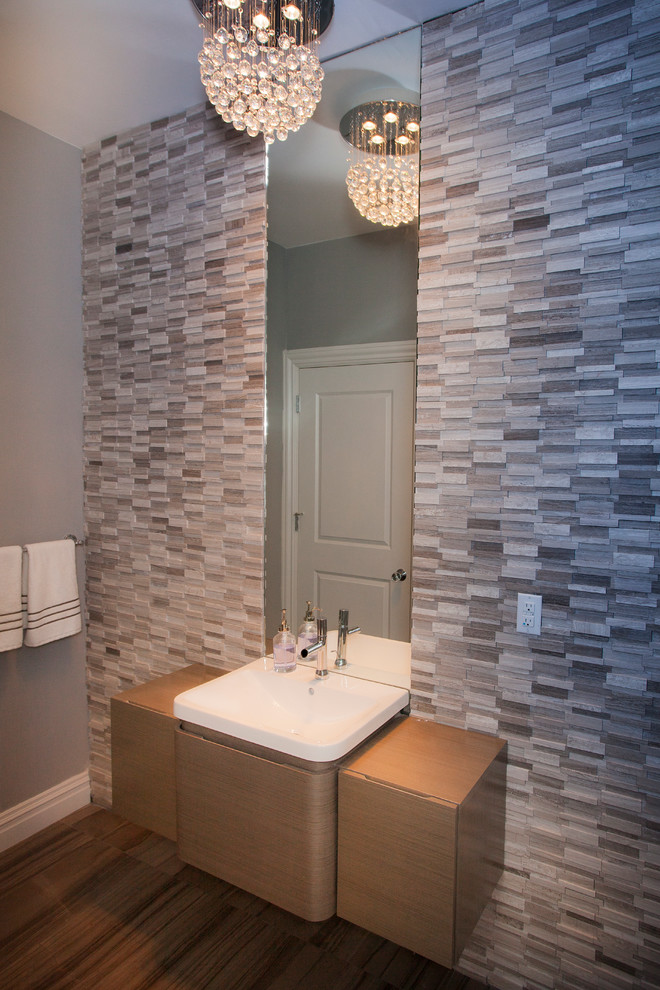 Small modern shower room bathroom in New York with flat-panel cabinets, light wood cabinets, mosaic tiles, medium hardwood flooring, an integrated sink, quartz worktops, grey tiles, grey walls, a single sink and a floating vanity unit.