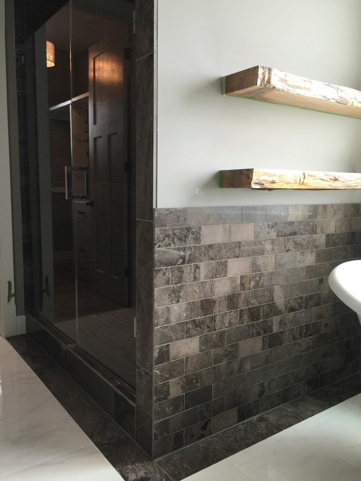 This is an example of a large traditional ensuite bathroom in Calgary with raised-panel cabinets, dark wood cabinets, a freestanding bath, an alcove shower, a one-piece toilet, multi-coloured tiles, stone tiles, white walls, ceramic flooring, a vessel sink and granite worktops.