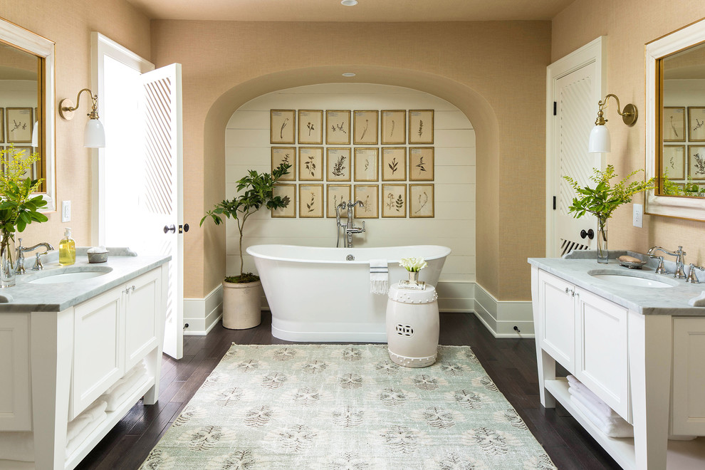 Immagine di una stanza da bagno padronale country con ante a filo, ante bianche, vasca freestanding, vasca/doccia, pareti beige, parquet scuro e pavimento marrone