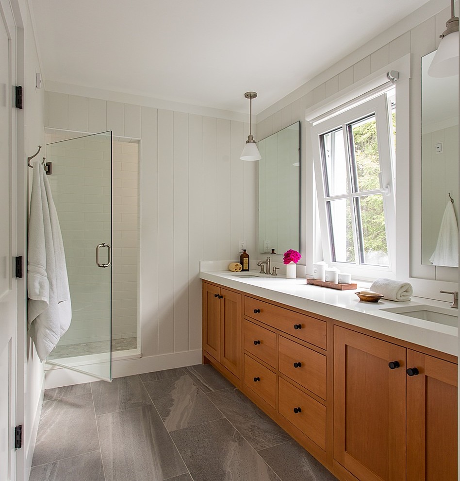 Пример оригинального дизайна: ванная комната среднего размера в стиле неоклассика (современная классика) с белой плиткой, плиткой кабанчик, белыми стенами, душевой кабиной, серым полом, фасадами в стиле шейкер, фасадами цвета дерева среднего тона, врезной раковиной, столешницей из искусственного кварца, душем в нише, душем с распашными дверями и зеркалом с подсветкой