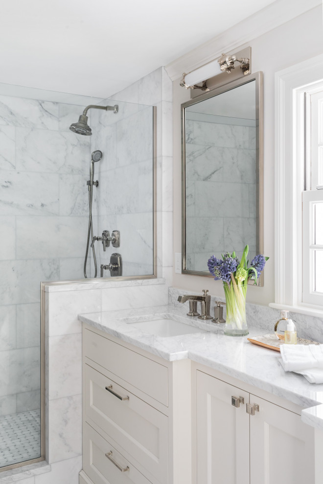 Bathroom - transitional white tile white floor bathroom idea in Boston with recessed-panel cabinets, white cabinets, white walls, an undermount sink, white countertops and marble countertops