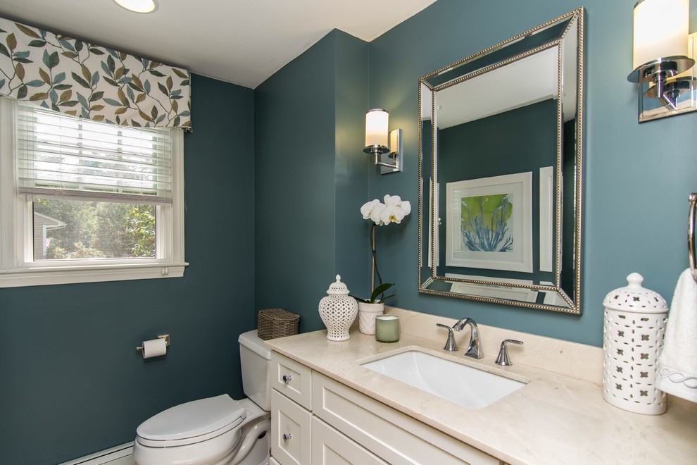 Bathroom - mid-sized contemporary bathroom idea in Boston with recessed-panel cabinets, white cabinets, a two-piece toilet, blue walls, an undermount sink and marble countertops