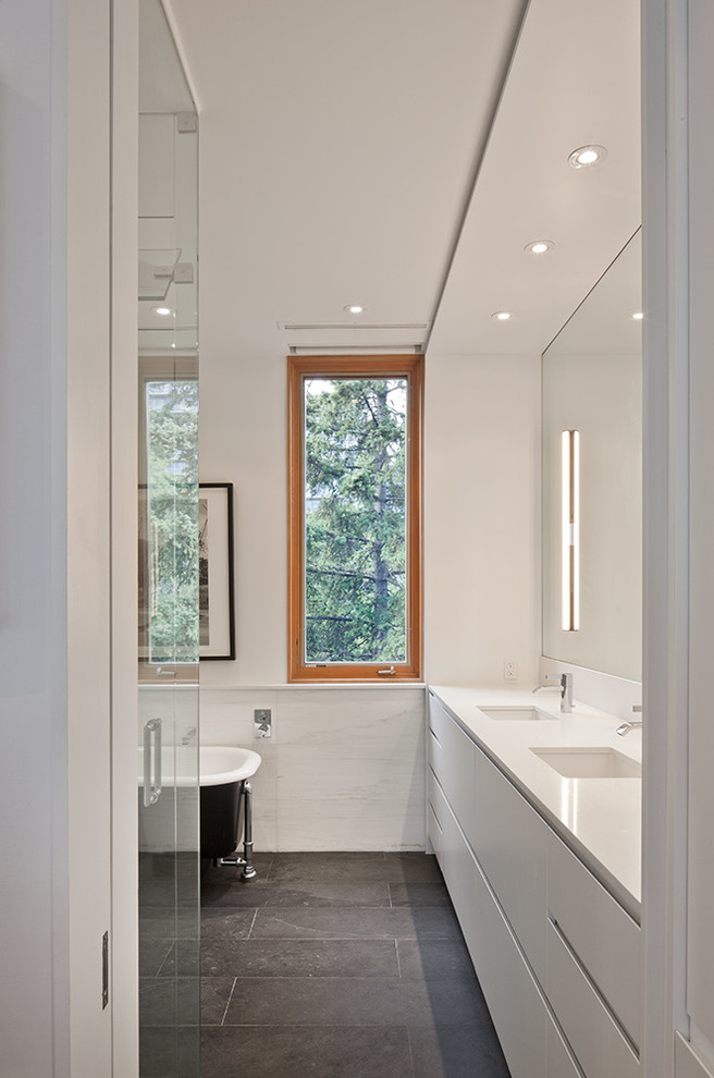 Inspiration for a medium sized modern ensuite bathroom in Toronto with a submerged sink, flat-panel cabinets, white cabinets, engineered stone worktops, a claw-foot bath, a corner shower, white tiles, stone tiles, white walls and slate flooring.