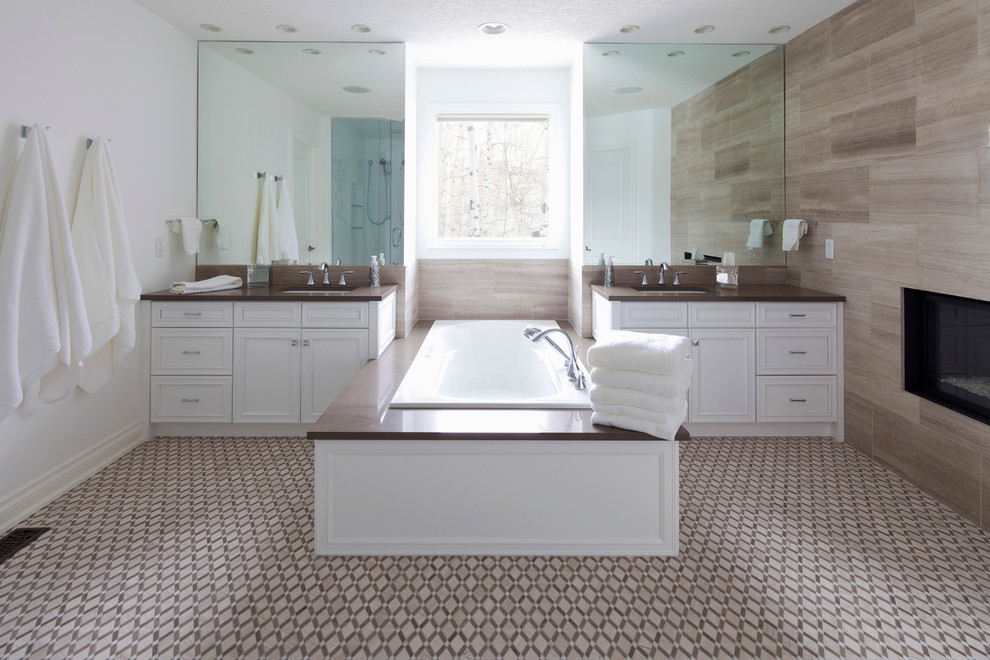 Inspiration for a transitional master beige tile and stone slab multicolored floor bathroom remodel in Calgary with an undermount sink, recessed-panel cabinets, white cabinets, white walls and a hinged shower door