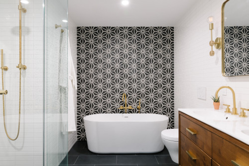 Design featuring a freestanding tub with black and white tiles