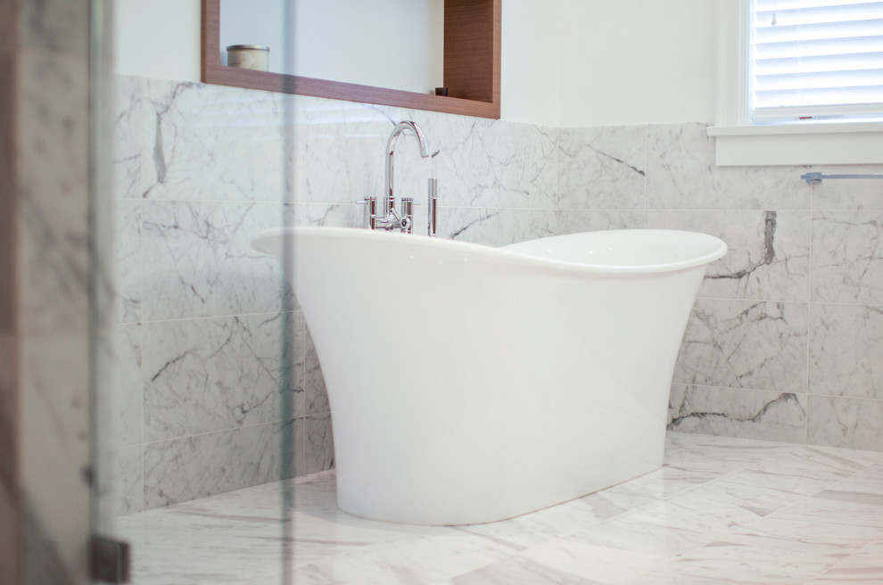 Traditional ensuite bathroom in Vancouver with a submerged sink, flat-panel cabinets, medium wood cabinets, engineered stone worktops, a freestanding bath, an alcove shower, white tiles, stone tiles, white walls and marble flooring.