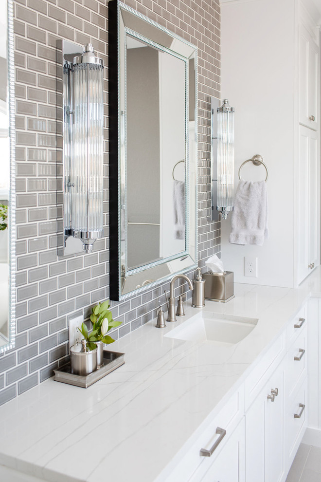 Design ideas for an expansive traditional ensuite bathroom in Denver with shaker cabinets, white cabinets, a freestanding bath, a corner shower, a one-piece toilet, white tiles, ceramic tiles, grey walls, porcelain flooring, a submerged sink, engineered stone worktops, grey floors, a hinged door and white worktops.