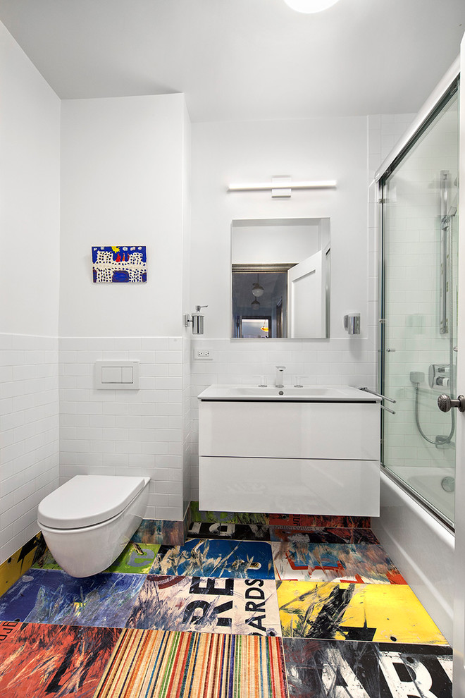 Inspiration for a contemporary white tile multicolored floor bathroom remodel in New York with a wall-mount toilet, white walls and a console sink