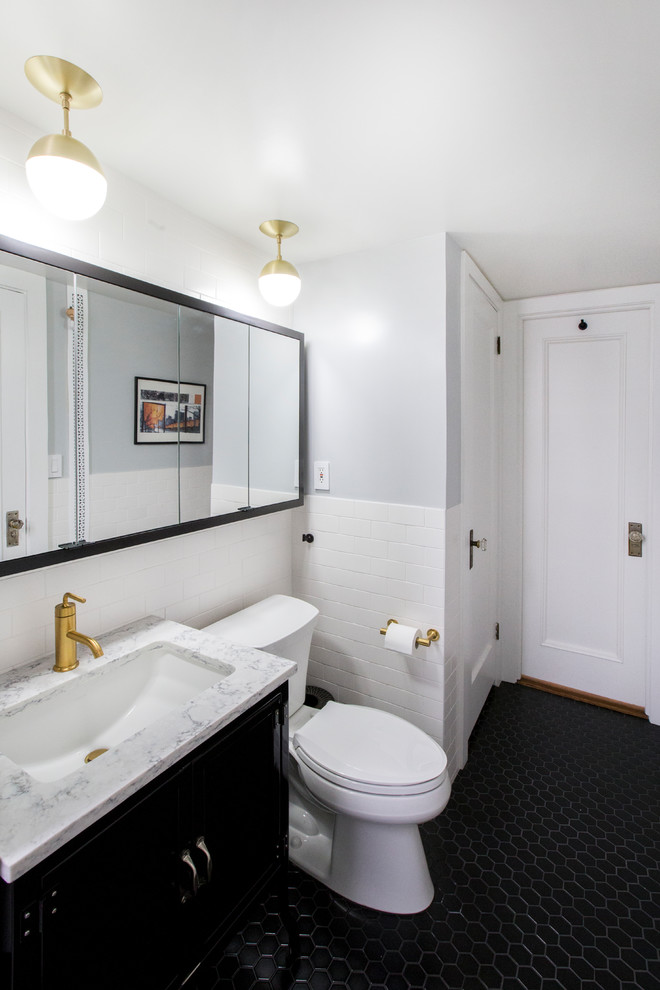 Inspiration for a mid-sized contemporary master white tile and ceramic tile porcelain tile and black floor bathroom remodel in New York with flat-panel cabinets, a two-piece toilet, gray walls, an undermount sink, quartz countertops and gray countertops