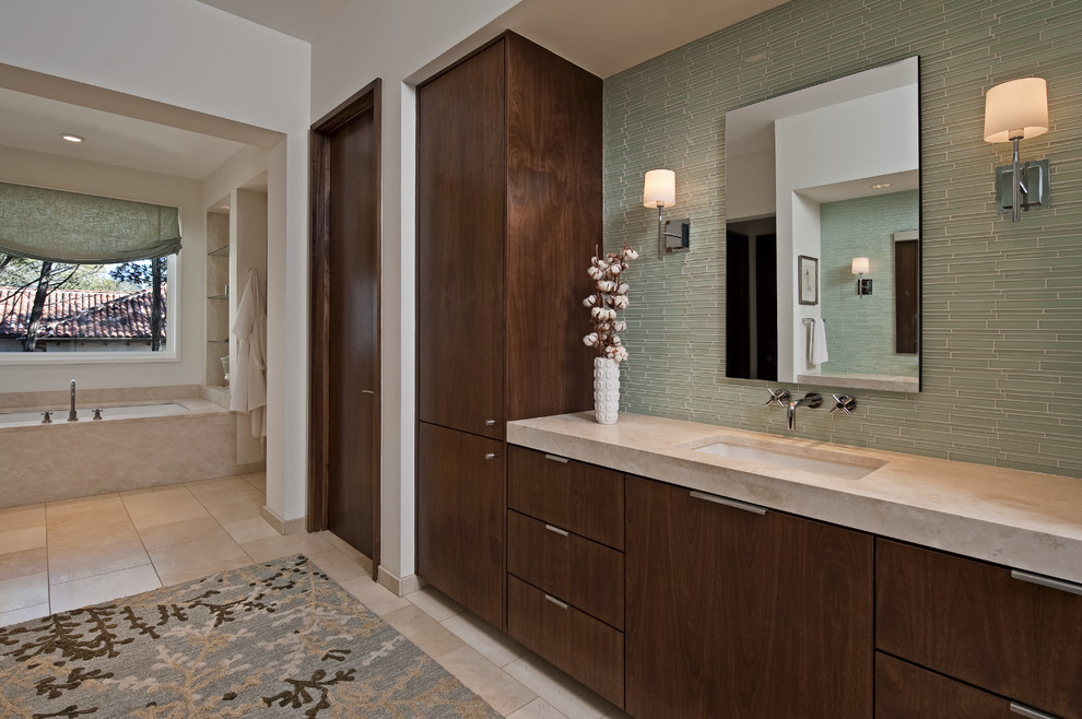 На фото: ванная комната в современном стиле с врезной раковиной и стеклянной плиткой с