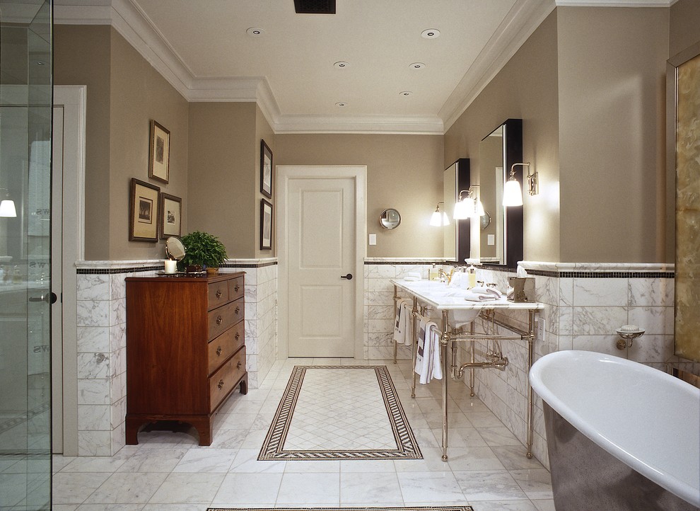 Example of a large classic master white tile and stone tile marble floor freestanding bathtub design in Houston with beige walls, dark wood cabinets, marble countertops and an undermount sink