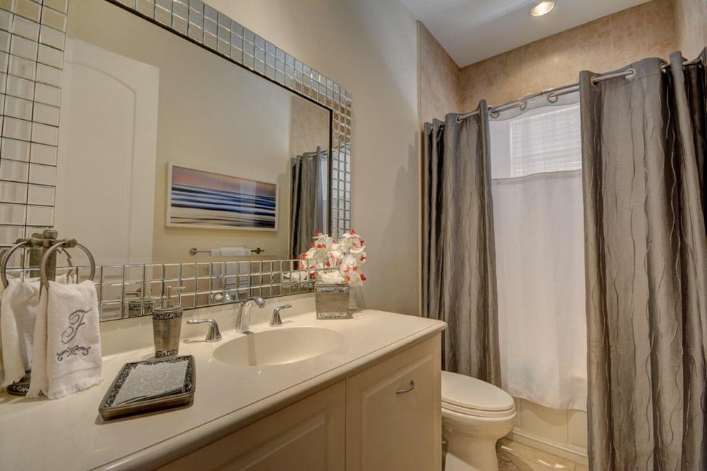 Bathroom - mid-sized transitional kids' beige tile and marble tile marble floor and beige floor bathroom idea in Miami with raised-panel cabinets, beige cabinets, a two-piece toilet, beige walls, an integrated sink and marble countertops