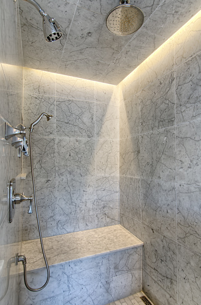 This is an example of a medium sized traditional sauna bathroom in New York with flat-panel cabinets, grey cabinets, a freestanding bath, a corner shower, a one-piece toilet, grey tiles, glass tiles, grey walls, marble flooring, a submerged sink and marble worktops.