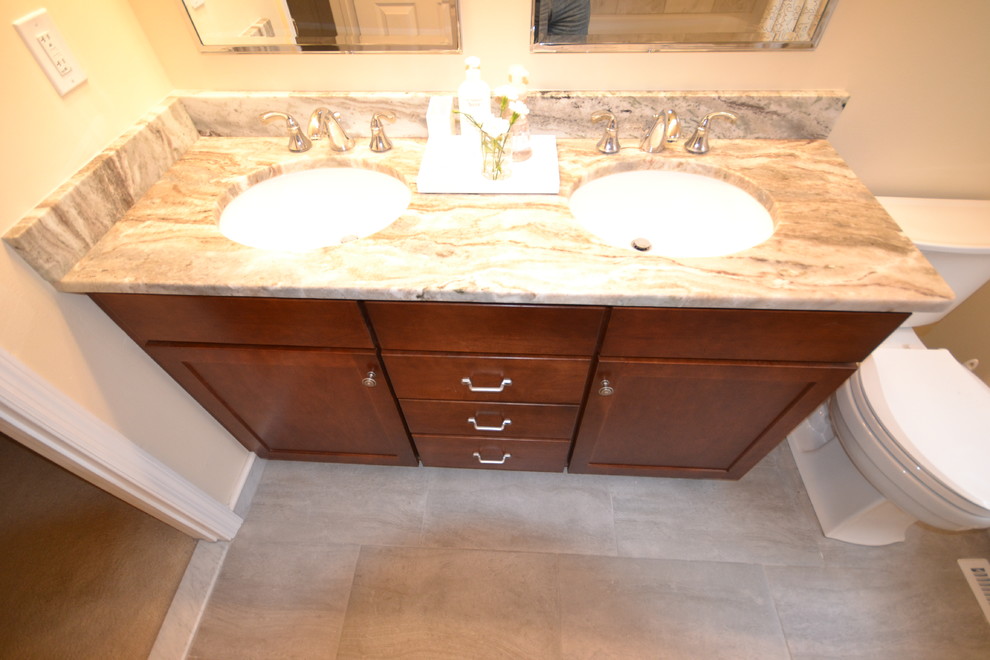 Design ideas for a large classic ensuite bathroom in Philadelphia with a vessel sink, flat-panel cabinets, medium wood cabinets, granite worktops, a double shower, a two-piece toilet, brown tiles, ceramic tiles, beige walls and ceramic flooring.
