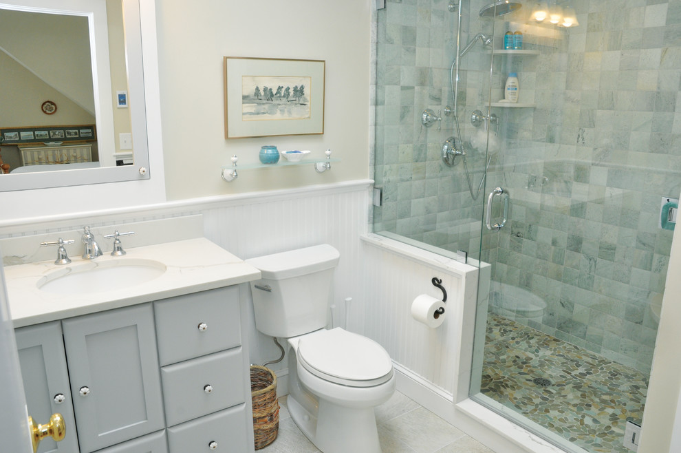 Coastal ensuite bathroom in Boston with grey cabinets, a double shower, a two-piece toilet, beige walls, marble flooring, a submerged sink, granite worktops, white floors, a hinged door and white worktops.
