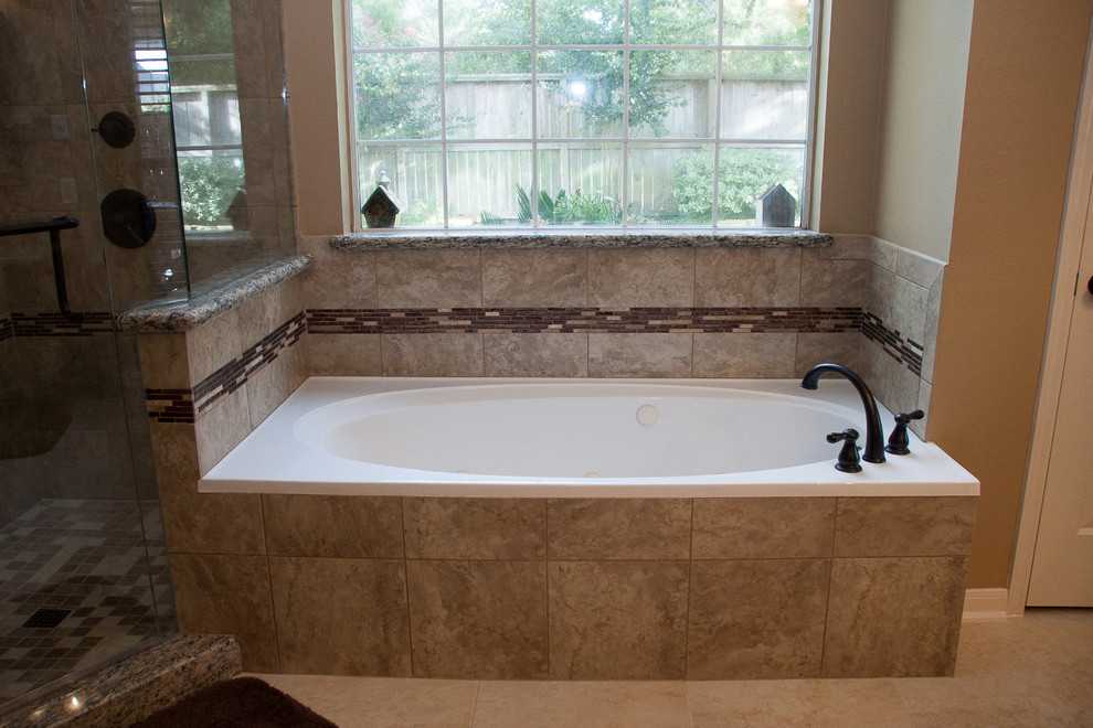 Photo of a large classic ensuite bathroom in Houston with granite worktops, a corner shower, a two-piece toilet, beige tiles, porcelain tiles, beige walls and porcelain flooring.