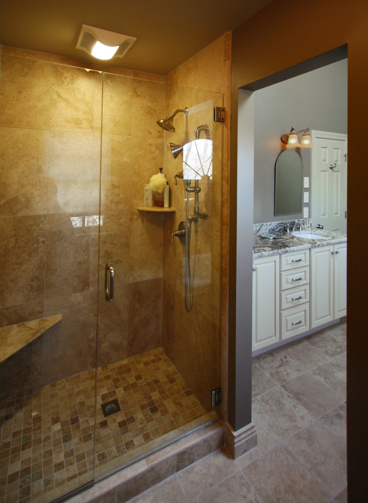 Example of a mid-sized tuscan master beige tile and stone tile travertine floor bathroom design in Richmond with an undermount sink, raised-panel cabinets, white cabinets, granite countertops, a one-piece toilet and gray walls