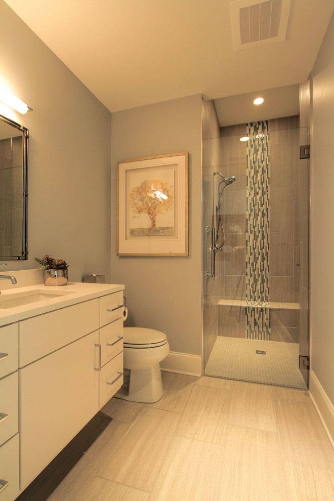 Inspiration for a mid-sized modern master glass tile ceramic tile walk-in shower remodel in Nashville with flat-panel cabinets, white cabinets, a two-piece toilet, gray walls, an undermount sink and solid surface countertops