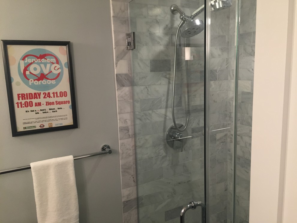 This is an example of a small contemporary shower room bathroom in Los Angeles with flat-panel cabinets, medium wood cabinets, a corner shower, a two-piece toilet, grey tiles, grey walls, ceramic flooring, a submerged sink, engineered stone worktops and metro tiles.