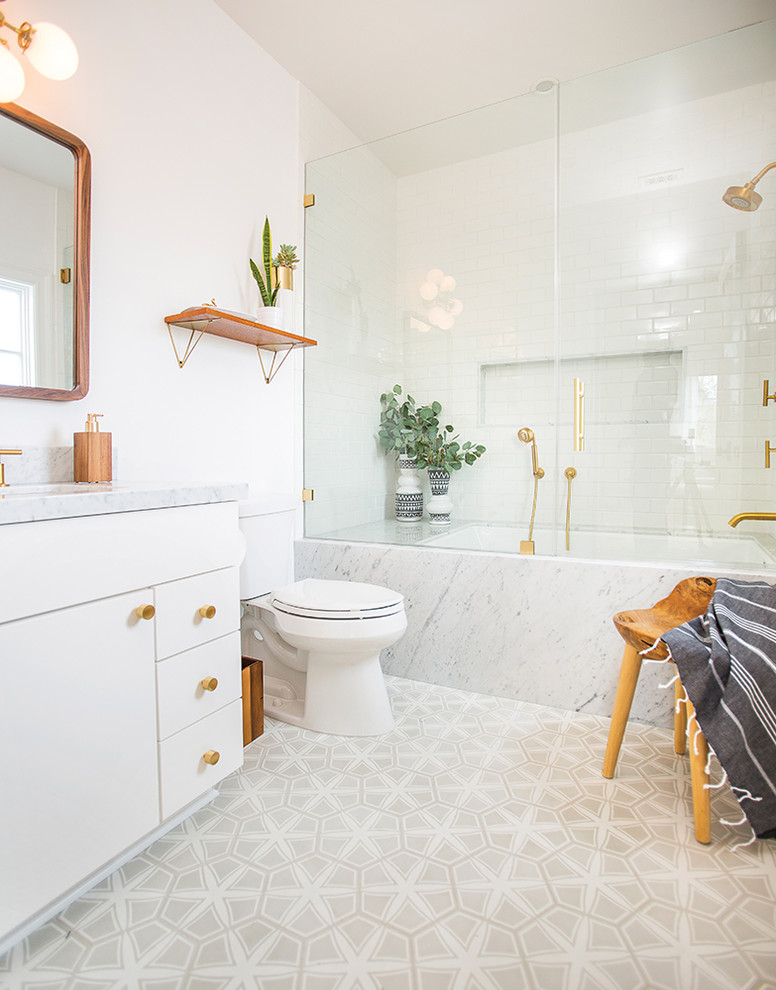This is an example of a medium sized midcentury bathroom in Los Angeles with flat-panel cabinets, white cabinets, an alcove bath, a shower/bath combination, a two-piece toilet, white walls, a submerged sink, marble worktops and a hinged door.
