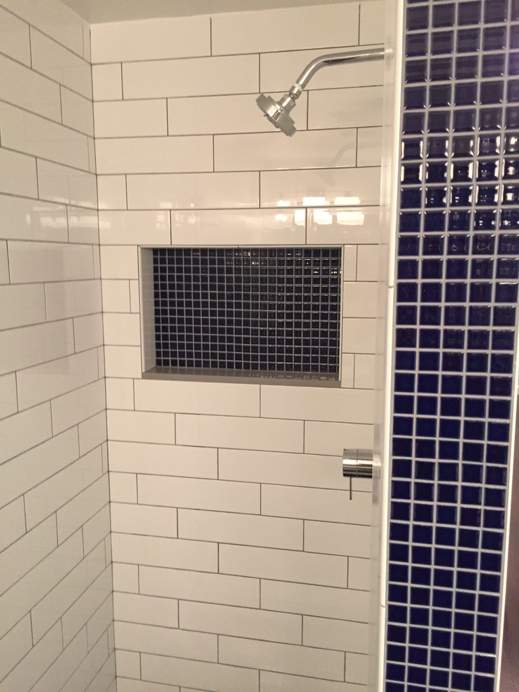 Photo of a medium sized traditional ensuite bathroom in Los Angeles with a submerged bath, a shower/bath combination, blue tiles, white tiles and metro tiles.